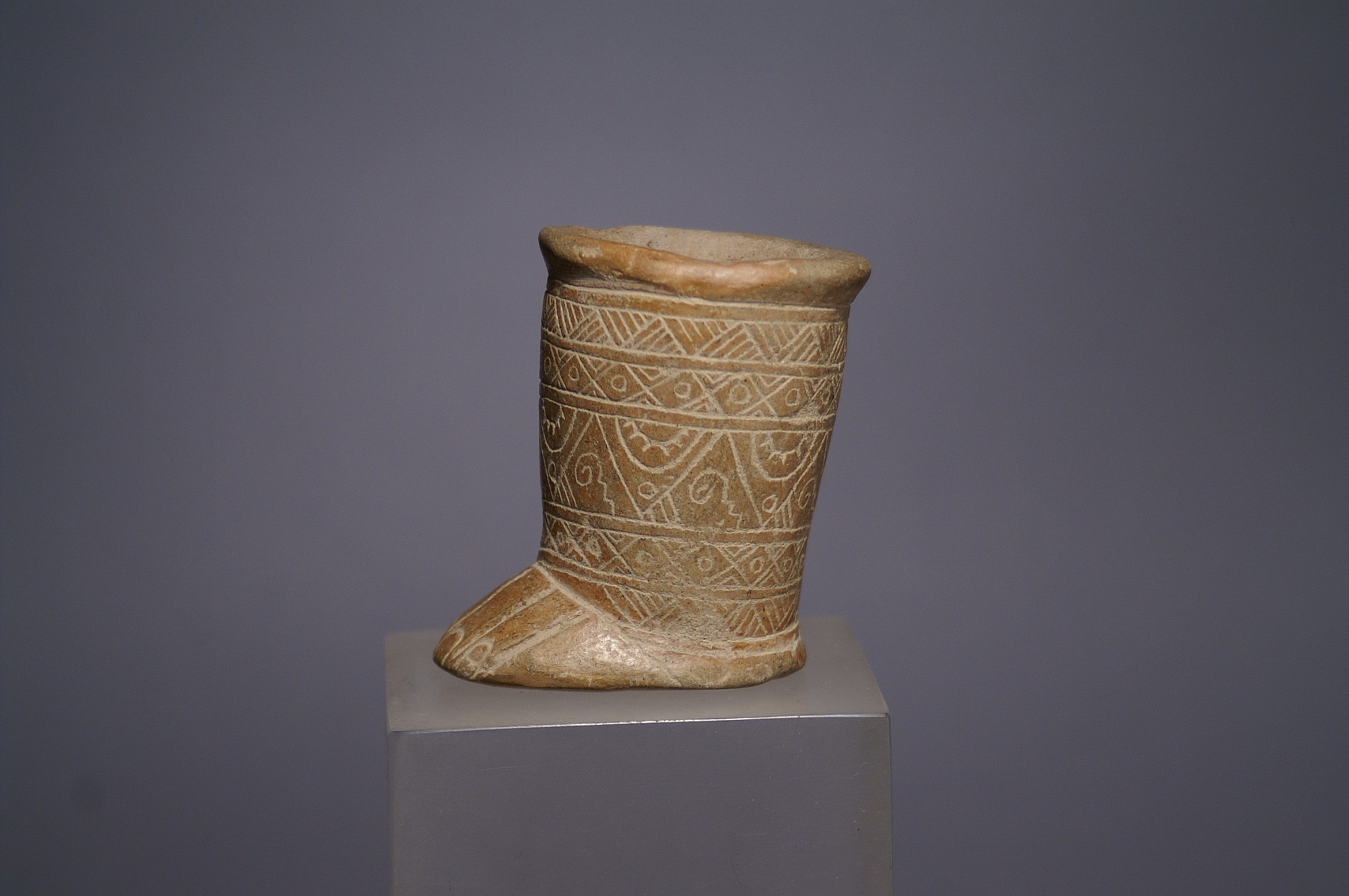 Ecuador, Monteno incised ceramic container in the form of a  foot with suspension hole
This is typical of a  lime container from the Monteno region and decorated with 4 bands of geometric designs.  A similar votive foot  vessel is illustrated in Amerindian Signs item 141
Media: Ceramic
Dimensions: Height 2 3/4"
$950
N1049
