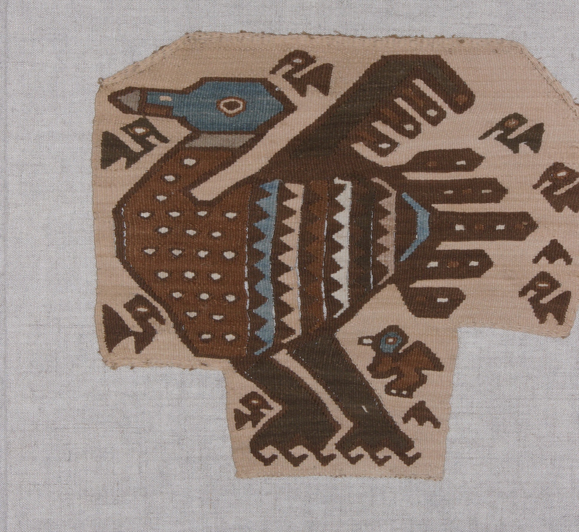 Peru, Pachacamac woven bird
This woven bird is brown, blue and white on a light brown ground, and has a smaller brown bird with a blue head behind it. There are a series of smaller, more stylized birds around the edge of the textile.  It was originally woven to be an emblem for tunic and was part of a large cache which was woven for tribute.  A similar bird is illustrated in TEXTILE ART OF PERU pg. 276.  This is a good example of a woven shaped  tapestry as it is not cut.
Media: Textile
Dimensions: Width 17" x Length 20" mounted / length 10 x width 9 in.
$7,500
93127