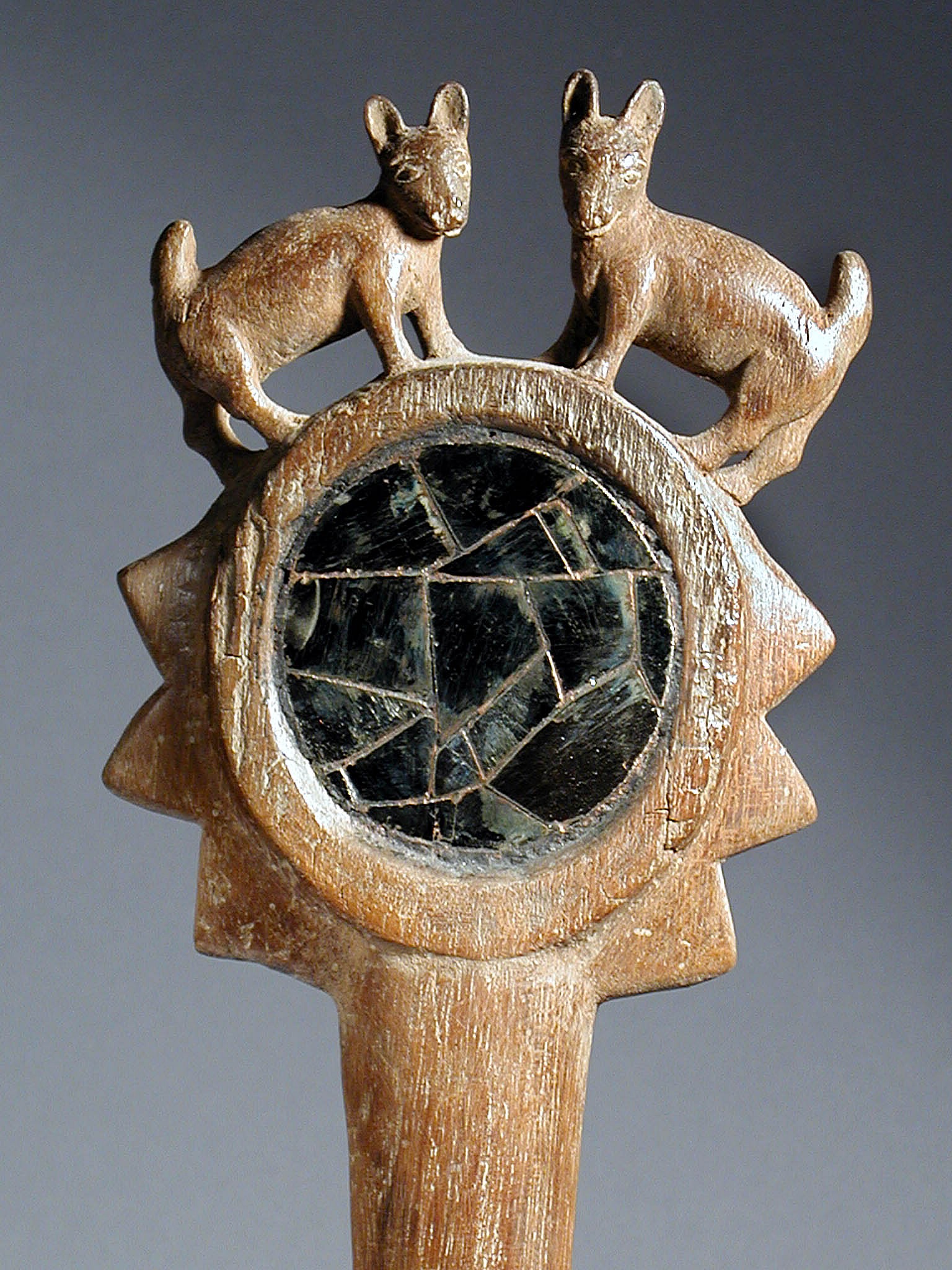 Peru, Wari Long Handle Wood Mirror Back with two deer carved on top
Elegantly carved wood handled mirror decorated with two felines perched on top facing outward.  The mirror frame is carved with a mace-like knobs to give an overall impression of a scepter. The verso side is plain.
Media: Wood
Dimensions: Length 14 1/4"
Price Upon Request
94189