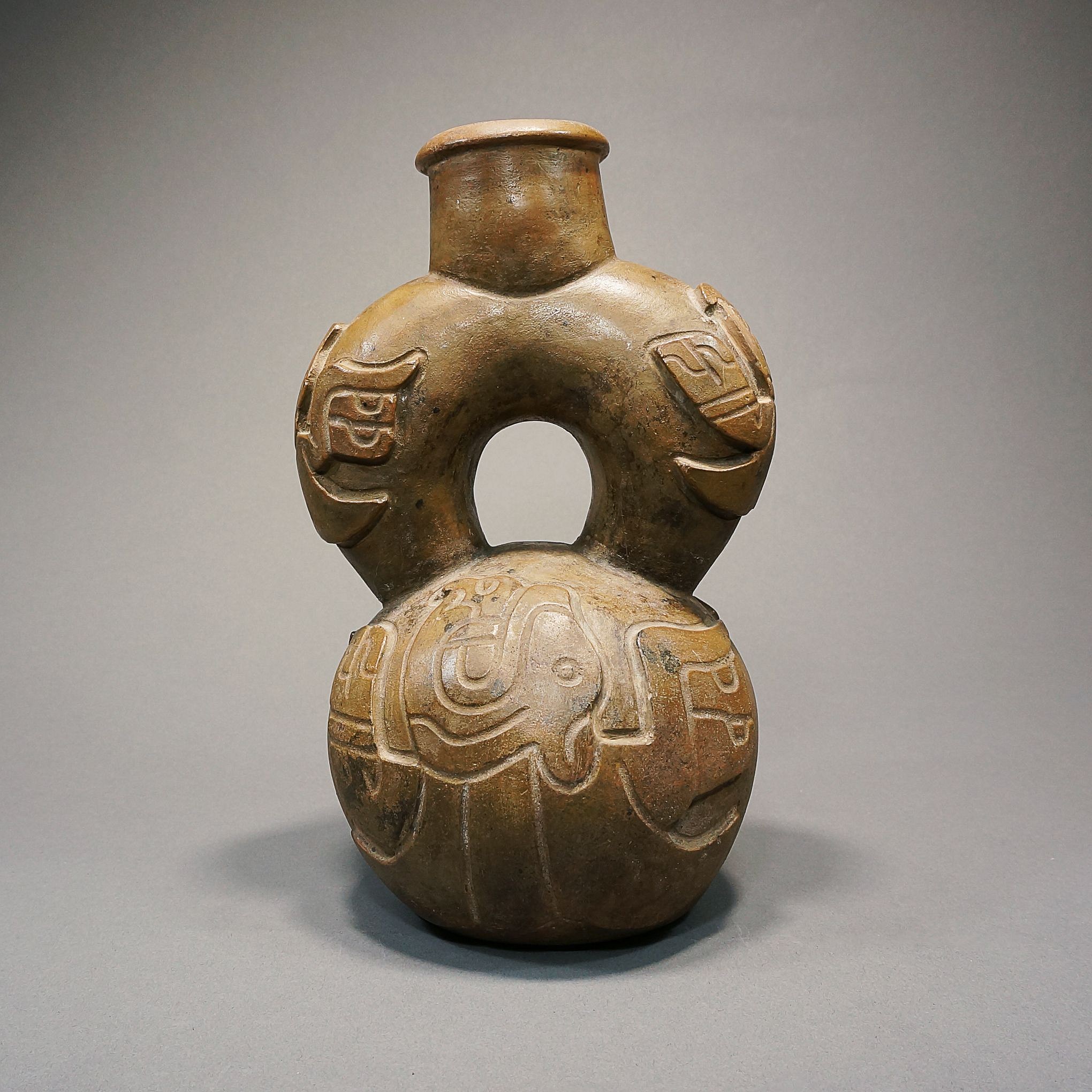Peru, Chavin Cupisnique Style Stirrup spout Vessel Decorated with a Harpy Eagle.
Media: Ceramic
Dimensions: Height: 8"
Price Upon Request
n2067