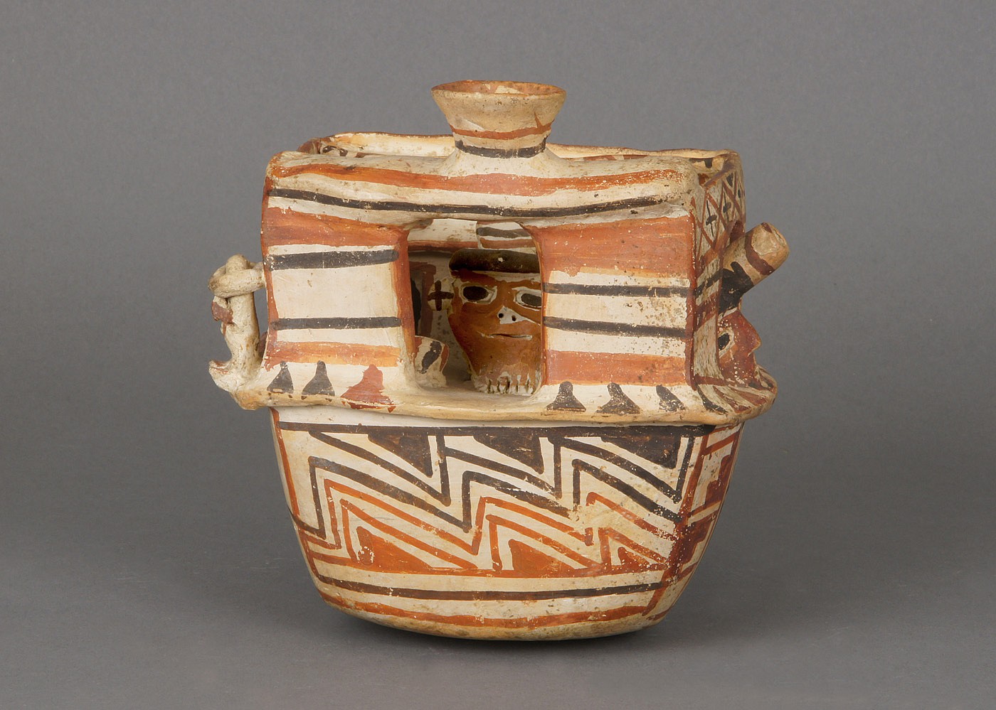 Peru, Recuay Ceramic House Scene
Creamware with geometric painted designs in red, orange and brown polychrome.  This is an elaborate house model with six figures modeled inside. This is one of the few houses with two windows and a door, as most of the known examples have only one opening. The house is also a good example of negative resist decoration, which was characteristic of Recuay ceramics. Similar examples are illustrated in Lapiner, "Pre-Columbian Art of South America" (1976: pls. 422 and 433).
Media: Ceramic
Dimensions: Length: 5 in x Width: 5 in. x Height: 5 in.
$8,000
M2032