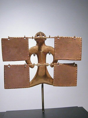 Colombia, Uruba style bird pendent with square plaque dangles
The bird has its wings arched to its sides and a flared tail and 4 dangles suspended on 2 bars.  The suspension holes are small, inside the neck and two bead like eyes.  The bird is a generalized composite of various birds, representing none in particular.  It is well cast with evidence of the carbon core intact.  There is a similar bird in The Gold Museum of Colombia in Bogota of the same size and posted on their website   http://www.banrep.gov.co/museo/esp/o_uraba_O32654C.htm
Period: Colombia, Gulf of Uruba, c. AD 500 - 1000
Media: Metal
Dimensions: Height 3 1/2" x Width 4 1/2"  Weight 33.6 grams
Price Upon Request
MM608