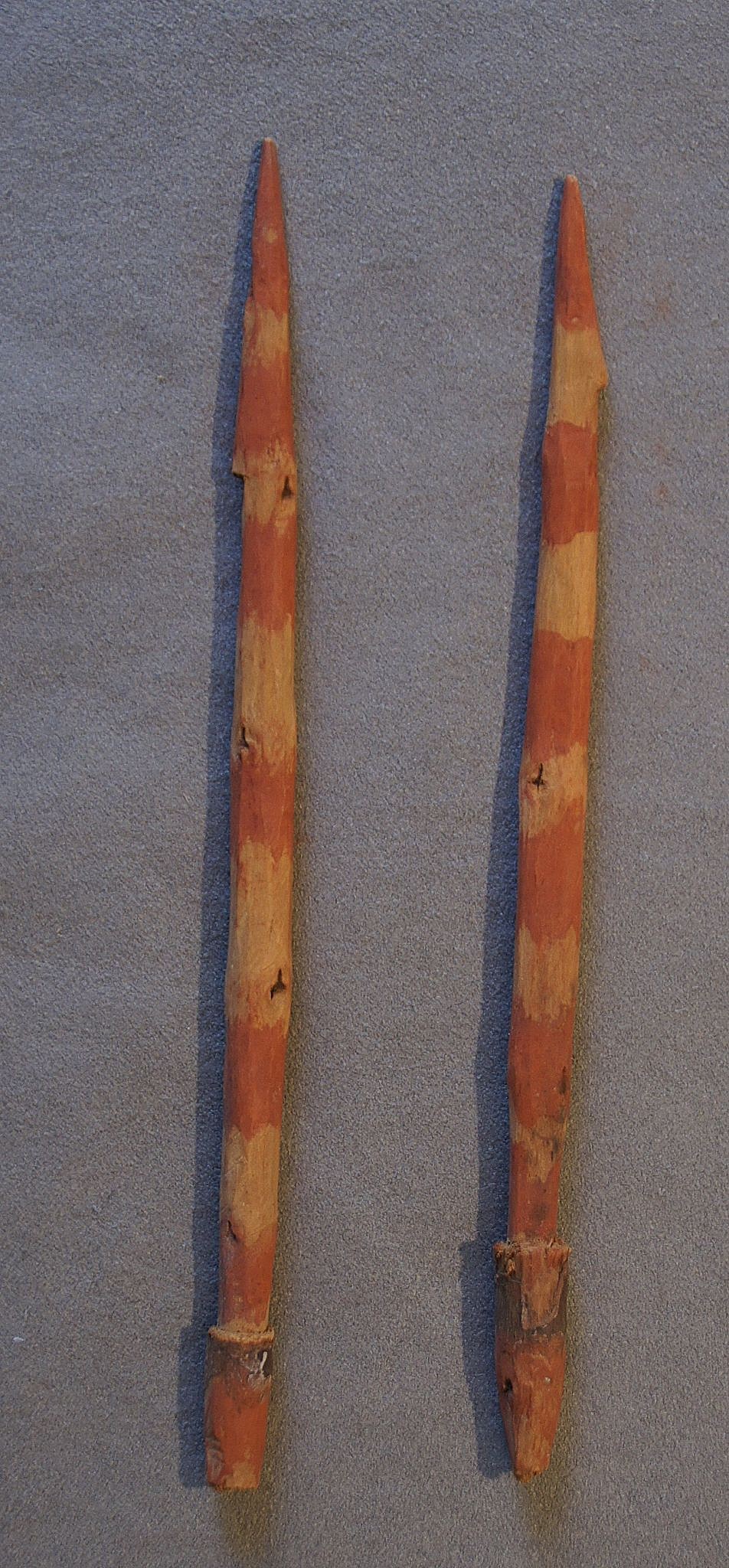 Chile, Two Early Carved Wooden Harpoon Points Painted with Red Stripes
These solid harpoon points are carved with a pointed tip and a notch to serve as a barb.  The opposite end is tapered to fit into a socketed throwing stick.  The red paint was usually used for items that were intended for use in the afterlife.
Media: Wood
Dimensions: Length: 7"
n6029