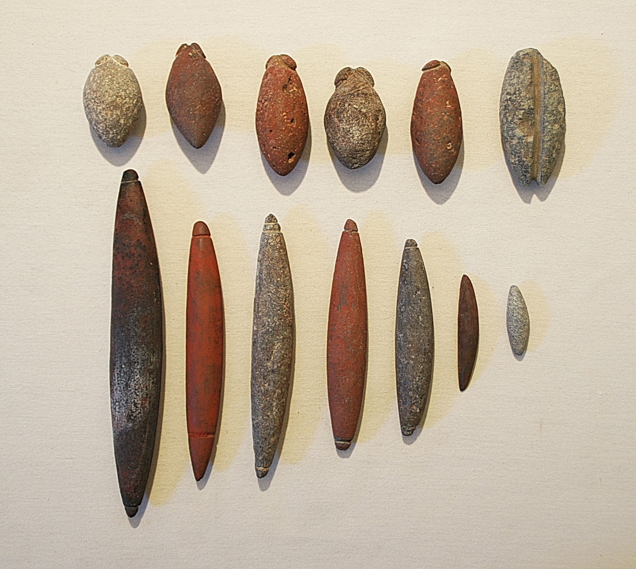 Chile, Thirteen Varied Stone Sinkers
Each sinker has notches at the end to attach to a line.  Different sizes are for different size fish.
Media: Stone
Dimensions: Bulbous sinkers: 1.75" - 3" LOblong sinkers:  1.5"-7" L
n6037