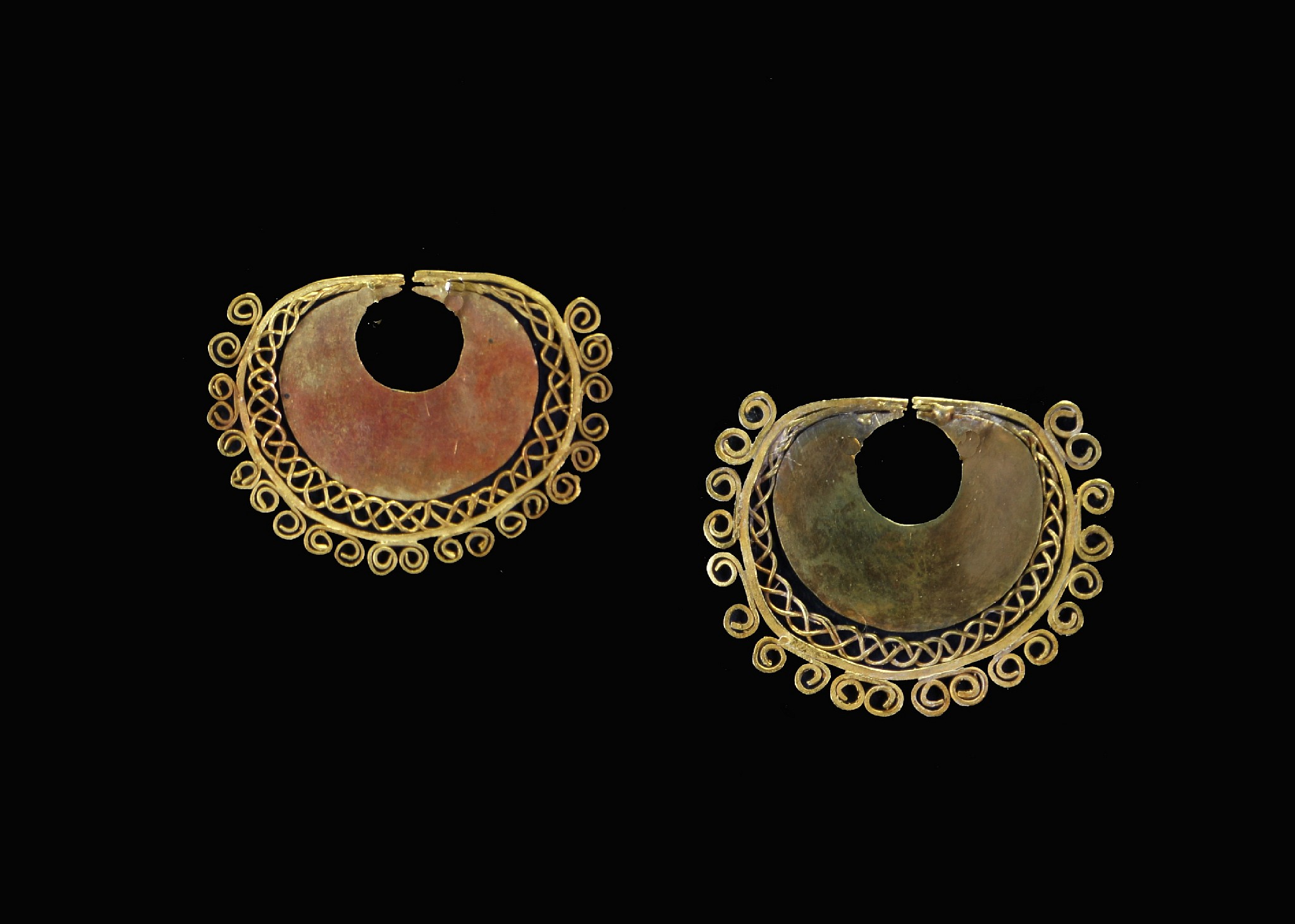 Peru, Early Nasca Gold Pair of Earrings with Filigree Decoration
A matched set of Nasca gold earrings with true filigree work and original archaeological patina.   The wire is skillfully soldered to the central disc.
Media: Metal
Dimensions: Width 1 3/8"     Weight: 3.8 grams
Price Upon Request
87044