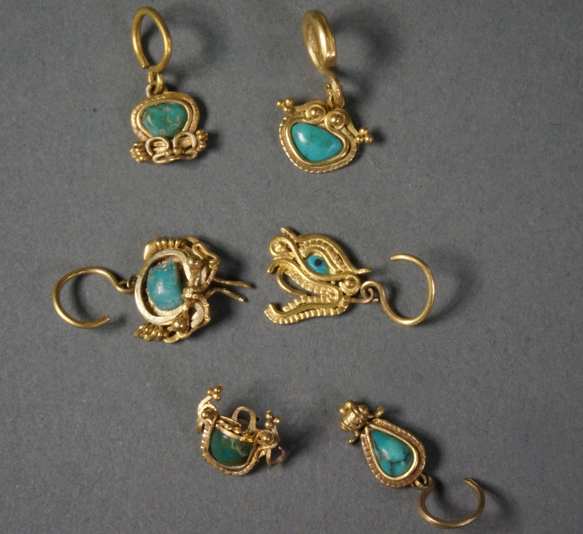 Ecuador, Six La Tolita Gold with Platinium Miniature Ear Ornaments with Turquoise
Each item has a suspension ring for ear ornaments.  These are excellent examples of early granulation technique.   Similar examples are illustrated in "The Gold of El Dorado," figure 506, and "Charms in pre-Columbian Ecuador," page 27.
Media: Metal
Dimensions: approx 1"each
$5,600
94203