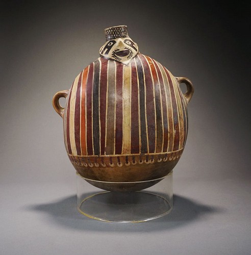 Ceramic: Nazca lug handled vessel wearing a striped tunic Price Upon Request