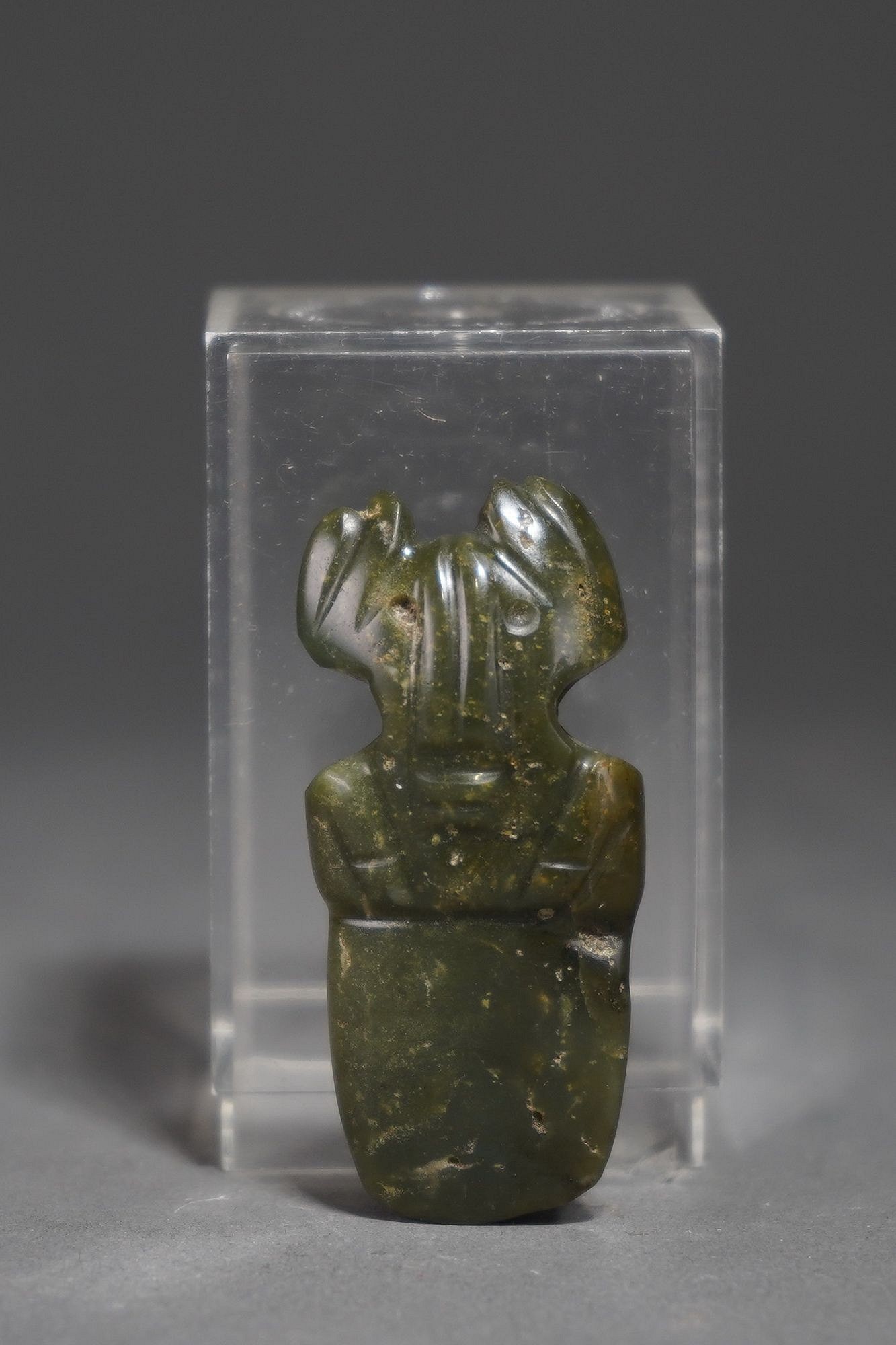 Costa Rica, Costa Rican Green Stone Figural Celt
This figurative celt is fashioned from a beautiful deep green stone and has large ears and hands held to its chest.   It would have been worn as an adornment as well as used as a shamanic amulet to ward of illness or bad spirits.
Media: Stone
Dimensions: Height 2.1/2"
$550
95050a