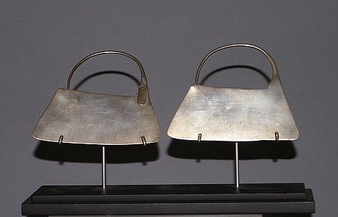 Chile, Classic Mapuche Trapezoidal Silver Ear Ornaments
This Mapuche ear ornaments are made from one continuous piece of hammered silver and feature the classic Mapuche trapezoidal shape.  According to Mapuche tradition, these earrings would have been handed down to family members through multiple generations.  They would likely have been repaired using primitive means by the family they belonged to.
Media: Metal
Dimensions: Width 3 3/4:  x Height: 3"    Weight: 1.06 oz.
$2,900
M9042