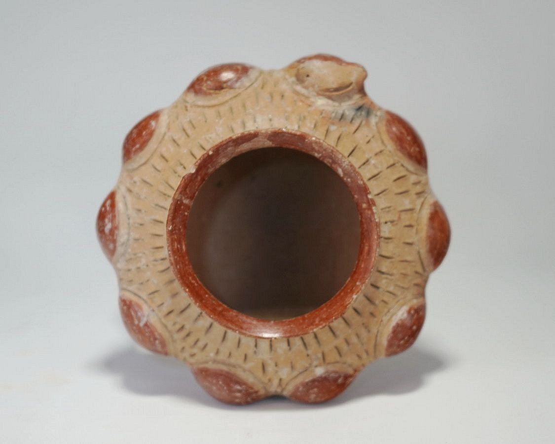 Ecuador, Classic Chorrera Miniature Bowl
This vessel is decorated with a circular ring of heads.  This style of vessel is known as a meeting themed vessel.  One head faces forward and the others appear to be in trance.
Media: Ceramic
Dimensions: Height: 2.5" x Diameter: 4.5"
$1,500
m6106