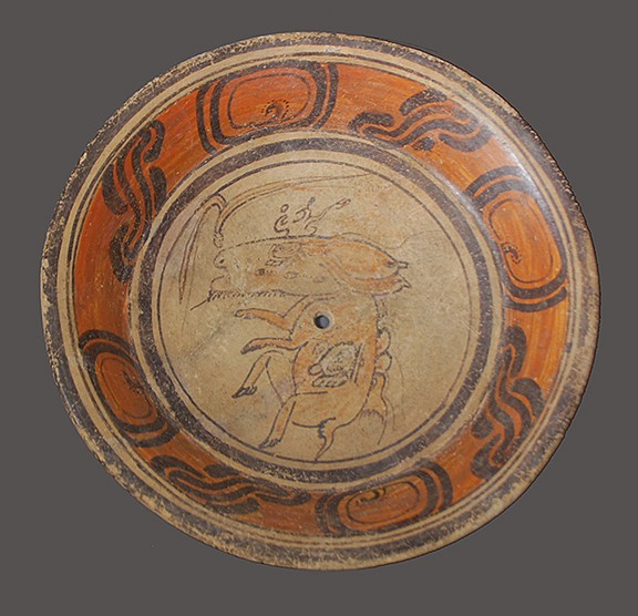 Guatemala, Mayan Ceramic Plate with Capybera and Glyphs
This beautiful plate features a Capybera, a giant rodent with an unusual large rectangular head that is native to South America.  Cabyberas are highly social animals that inhabit dense forest areas and were hunted by the ancients as a meat source.  There is a kill hole in the center of the plate above a glyph on the animal.
Media: Ceramic
$6,000
N6013