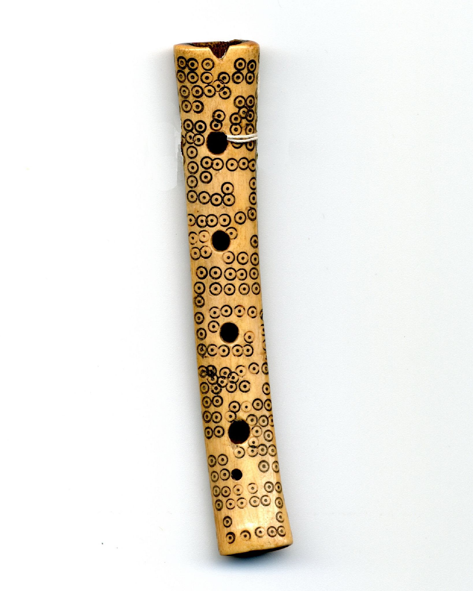 Peru, Chancay Miniature Bone Flute with Incised Circles and Four Holes
A flute made of animal bone decorated with over 175 circles with dots, likely representing the spots of the jaguar.  There are two suspension small suspension holes on the opposite side.  Similar bone flutes are represented in MUSIC OF ELDORADO by Dale A. Olsen pg.39   There have not been any studies so far to determine the symbols of the circles.  Acquired in 1992 from Robert Kommer, Washing State.
Period: Peru, Central Coast, c. AD 900 - 1350
Media: Bone
Dimensions: Length: 3 1/2"
$475
92092