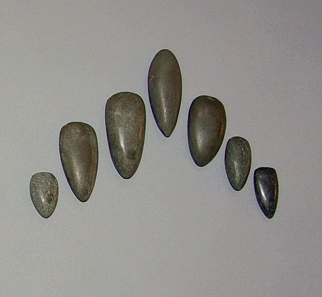 Dominican Republic, Seven Small Dark Greenstone Celts as Tools
Ranging in shape from oblong to petaloid, these stones were used as tools for fine work.  The varied shapes allowed for fine work a variety of sizes of amulets.
Period: Dominican Republic, Taino, Early Classic Period, c. AD 600 - 1000
Media: Stone
Dimensions: Length: 1 1/4" to 2 7/8"
$1,500
99454