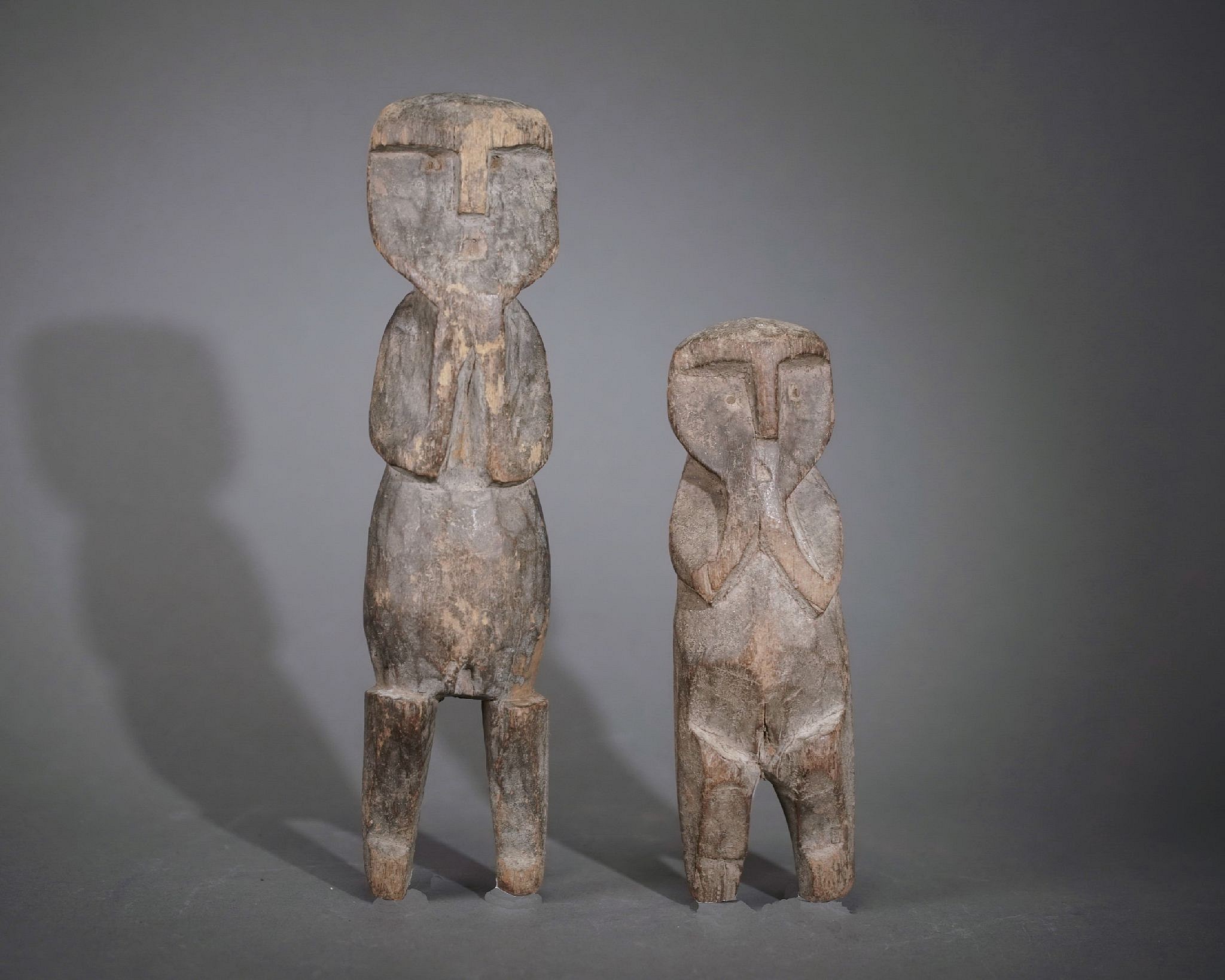 Peru, Huacho Carved Wooden Pair of Abstract Female Figures
These figures are unusual in form and share a similarity with 19th century Mapuche burial markers and are thought to be totems.  Each figure holds its hands to the mouth have pronounced knees and display female genitalia.  The backs of the figures are flat.  Carved wooden figures are mostly found in burials during the Late Intermediate Period.
Period: Peru, Huacho Valley, Late Intermediate Period, c. AD 700 - 1100
Media: Wood
Dimensions: HeightA: 7 1/2"  Height: B 5 1/4"
$1,950
p2042AB