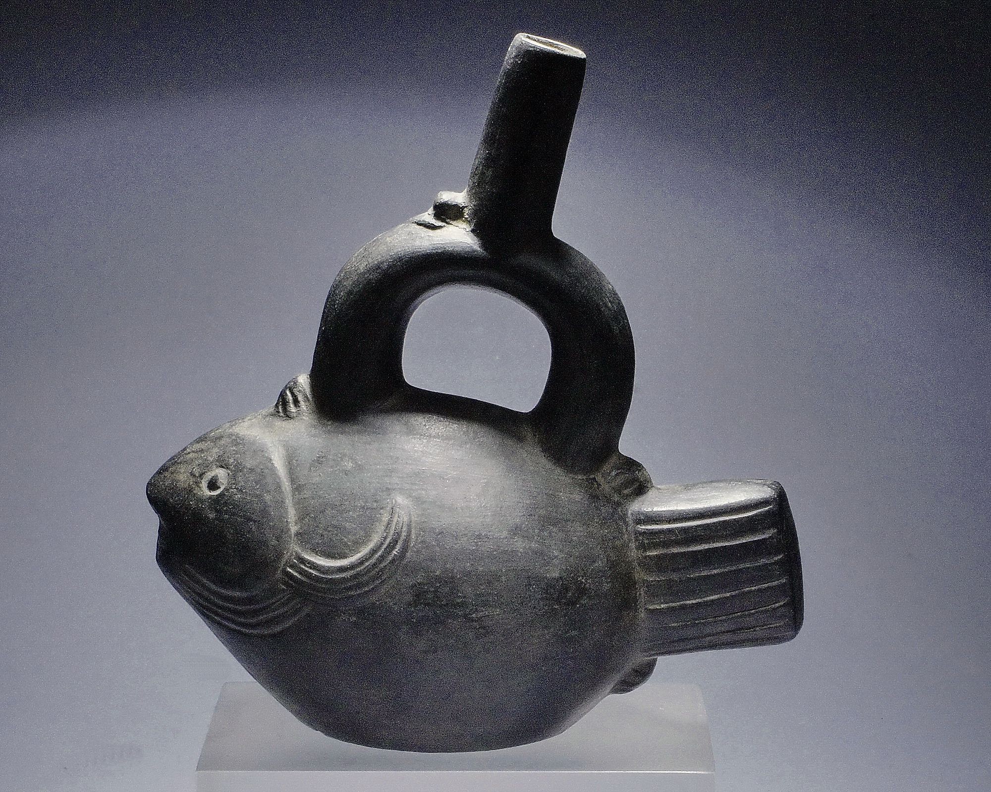 Peru, Blackware Vessel in The Form of a Bonito
This fish is identifiable as a bonito by its pointed mouth and teeth.  In the same family as tuna, but smaller, the bonito is one of the most abundant fish in north coastal Peru.
Period: Peru, Lambayeque, North Coast, c. AD 500 - 1100
Media: Ceramic
Dimensions: Length: 8" x Height: 8 1/4"
$1,500
n2016