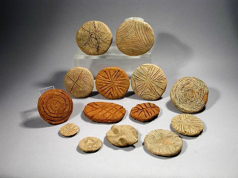 Dominican Republic, Taíno Group of 14 Round Ceramic Seals or Stamps
This eclectic group of ceramic seals of is decorated with various geometric designs, one with zoomorphic motif (frog or bat) on the grip.  The Taíno dipped these stamps in pigments made from crushed bija and jagua seeds and then imprinted them on their own skins for ceremonial events. Similar examples are illustrated in "Altos de Chavon", p. 28.
Period: Dominican Republic, Taíno, c. AD 1000 - 1500
Media: Ceramic
Dimensions: Largest  diameter: 3" 
smallest diameter: 1 1/4"
$900
99155