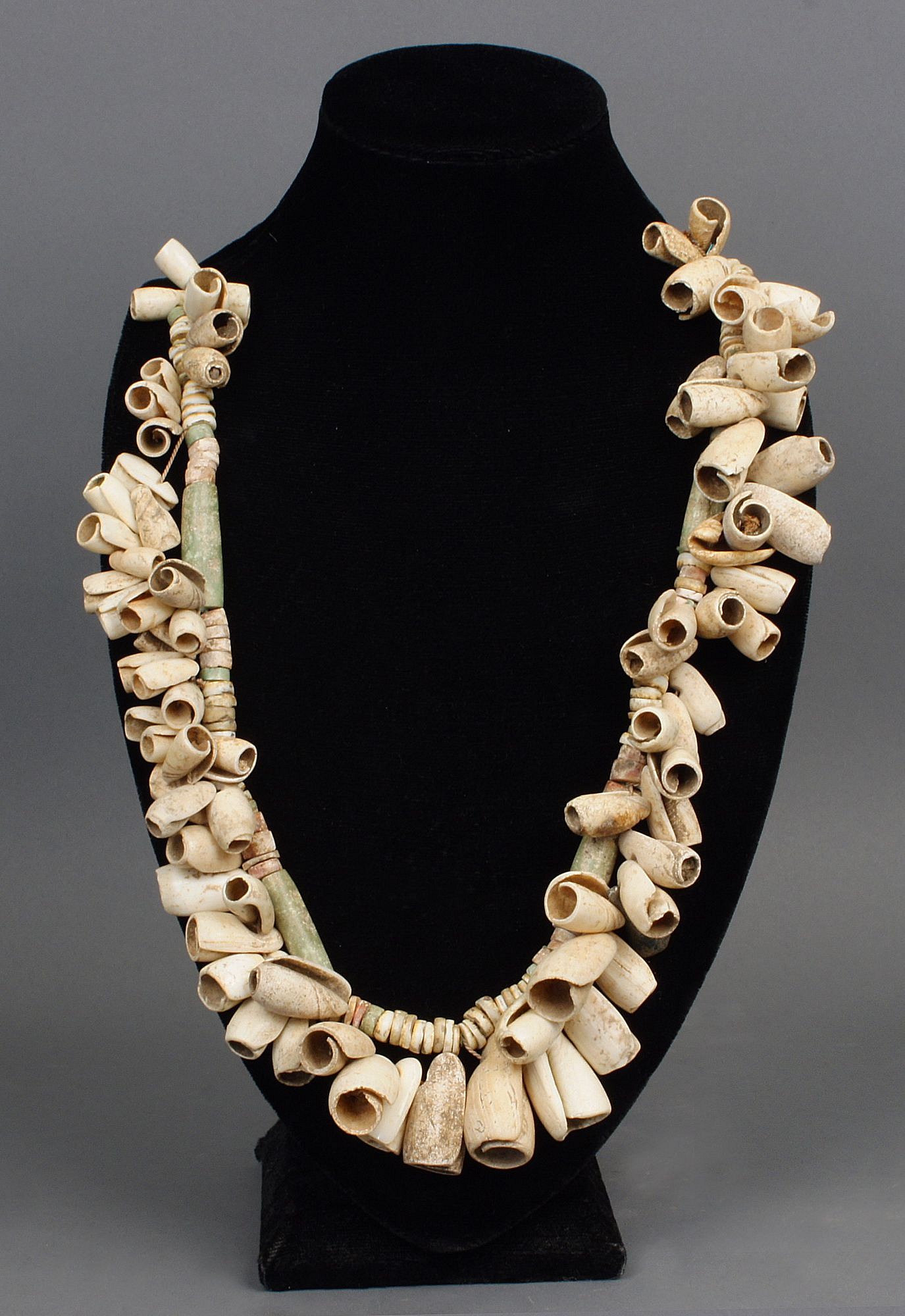 Dominican Republic, Taíno Necklace Composed of Operla Snail Shells
These cone snail (gastropoda Conidae) shells were by the ancient Taíno as beads and would have been worn on necklaces by people of high wealth and status.  The beads are ancient, but this necklace is modern assembled, with a design that resembles an ancient necklace.
Media: Shell
Dimensions: Length: 21"
$3,500
99376