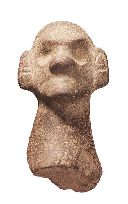Dominican Republic, Taíno Carved Stone Pestle  Handle Section with a Monkey Deity Head
This finely finished pestle handle has incised circles on the top and the back of the deity's head, which creates an abstract face.
Period: Dominican Republic, Taíno , c. AD 1000 - 1500
Media: Stone
Dimensions: Length: 4" x Diameter: 2"
98199