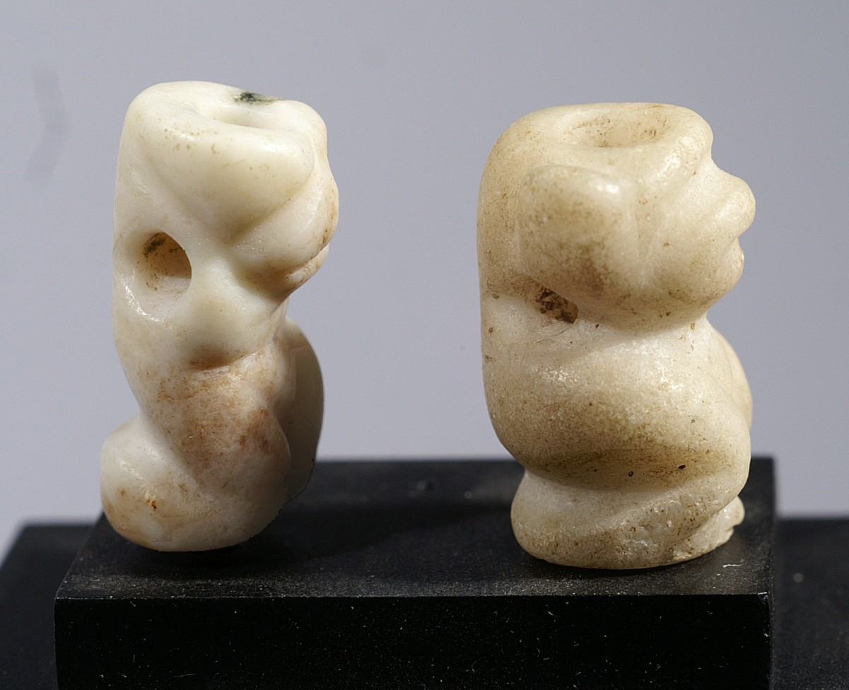 Dominican Republic, Taíno  Miniature Amulets of 2 Crouching Dog Figures
Dogs were believed to escort the dead to the otherworld and to also watch over their spirits. They are often shown on amulets and were worn as protective charms in memory of important ancestors. When a chief died, some of his amulets were buried with him, but the majority were given as gifts to secure the allegiance of lords to the successive chief.
Period: Dominican Republic, Taíno , c. AD 1000 - 1500
Media: Stone
Dimensions: Height: 6/8" each
99373