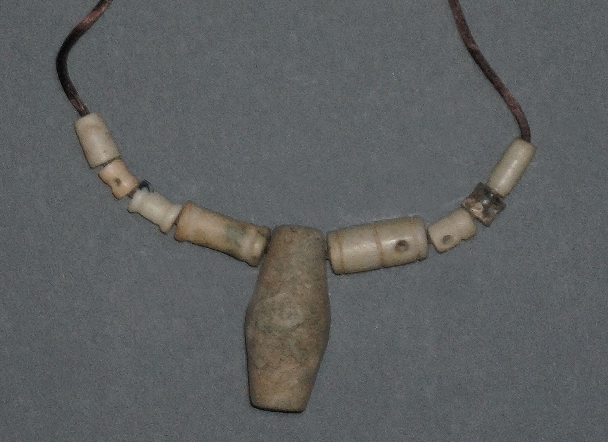 Dominican Republic, Taíno  Necklace with Nine Carved Stone Beads in Varying Sizes
Necklace of nine Taíno  carved stone cylindrical beads in a variety of sizes.  It took great skill to drill long holes and sometimes even greater skill for small stones, as they often break in the drilling process.
Period: Dominican Republic, Taíno , c. AD 1000 - 1500
Media: Stone
Dimensions: Lenght: 1/4" to 2"
99379