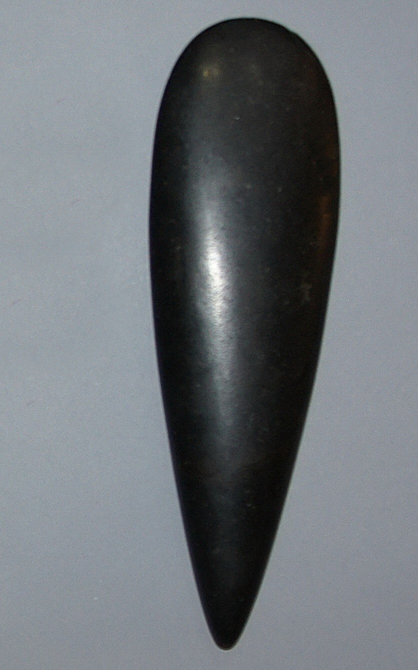 Dominican Republic, Taíno  Large Black Petaloid Celt
The smoothly polished surface and finely tapered teardrop form of this petaloid stone celt indicates that it was intended as a ceremonial object.  The term "petaloid" refers to the elongated, flower petal-like shape.  Black stone celts are among the scarcest of stone celts because the stone was particularly hard and required greater skill to carve.
Period: Dominican Republic, Taíno , c. AD 1000 - 1500
Media: Stone
Dimensions: Length: 10" x Width: 3"
MM016